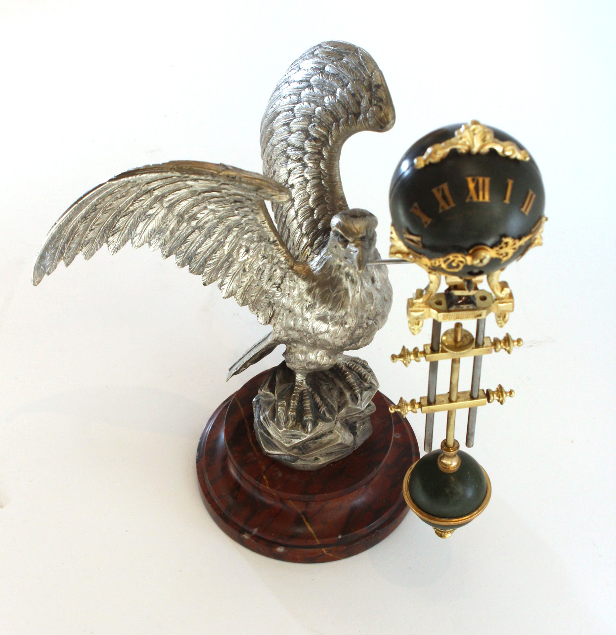 Mystery Swinging Clock on Eagle Sculpture Carlton Clocks